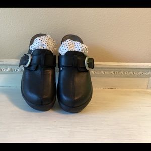 Leather crocs, on a platform sole w/studs and buckle.